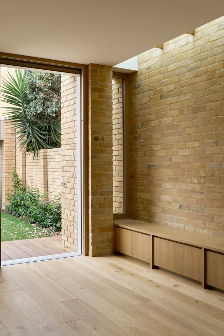 Built-in timber window seat and courtyard connection in a Fitzroy Passivhaus home
