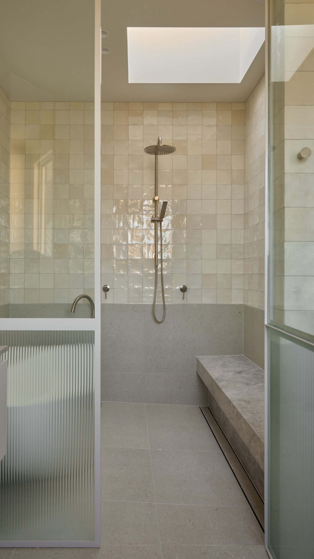 Walk-in shower with skylight and textured glazing in a Brighton bathroom