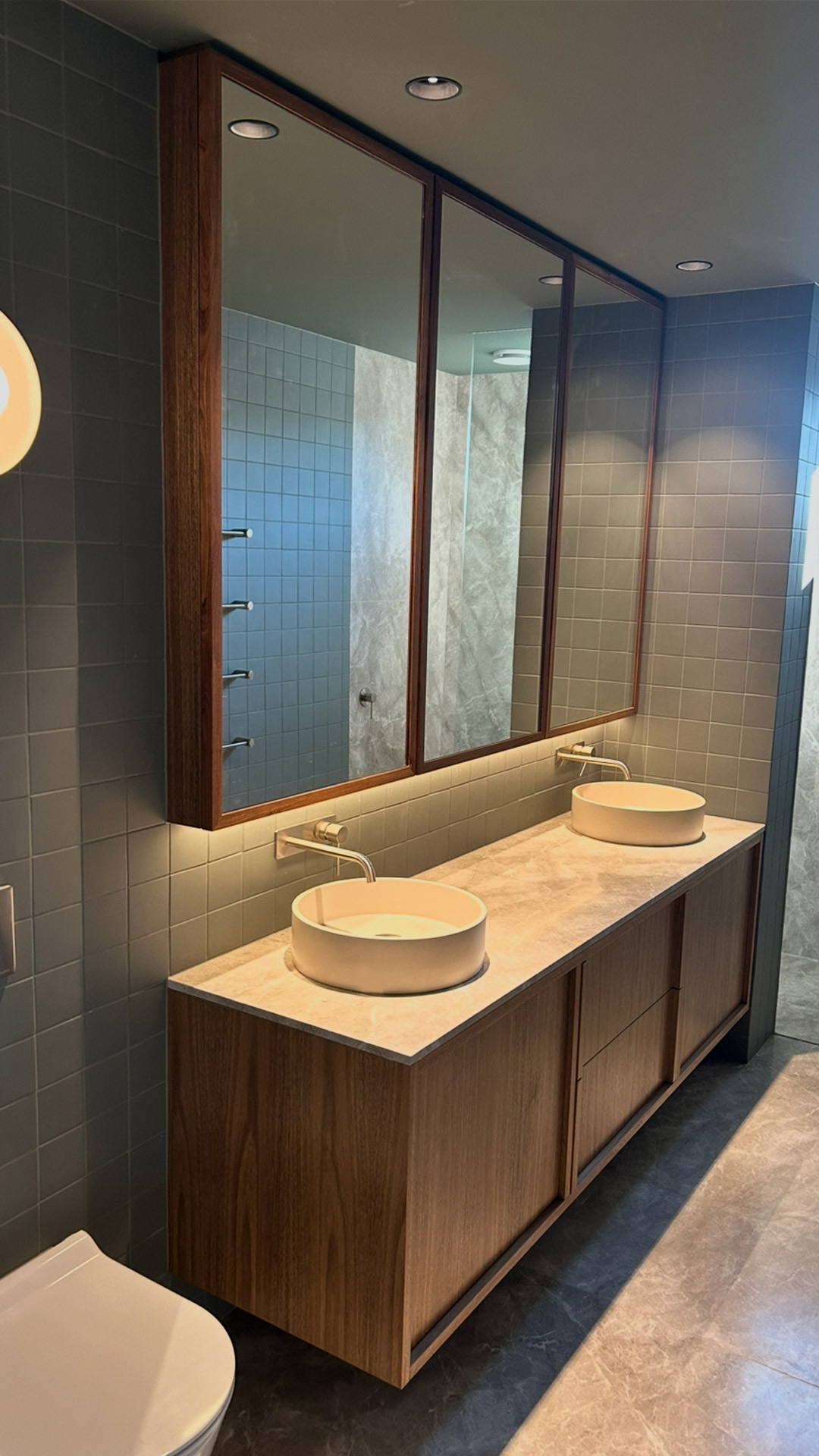 Timber vanity and natural stone bathroom in a Melbourne high-performance retrofit