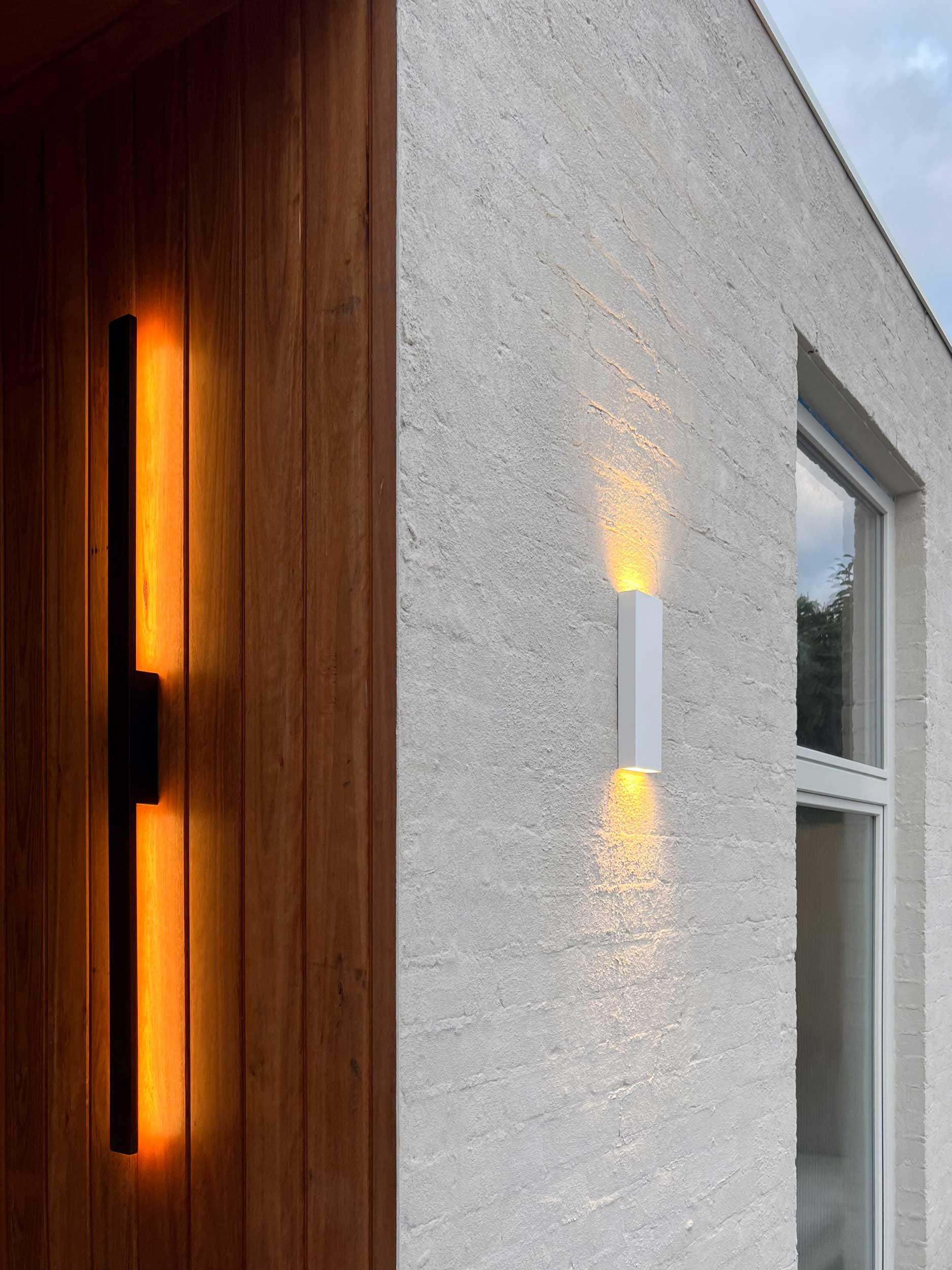 Custom home entrance with timber cladding and architectural lighting in Northcote
